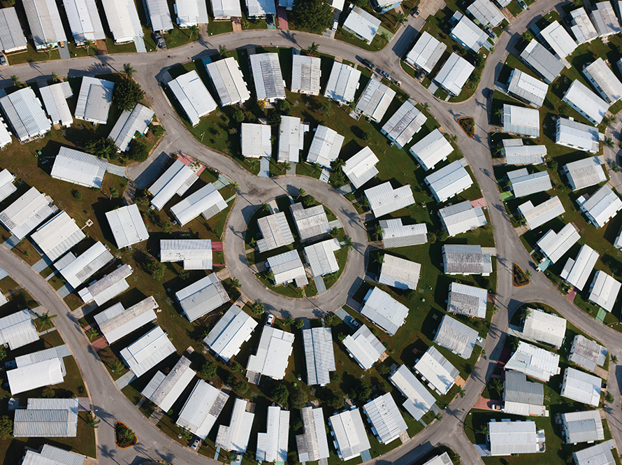 Aerial view of a suburban neighborhood with spiraling cul-de-sacs and white roofs