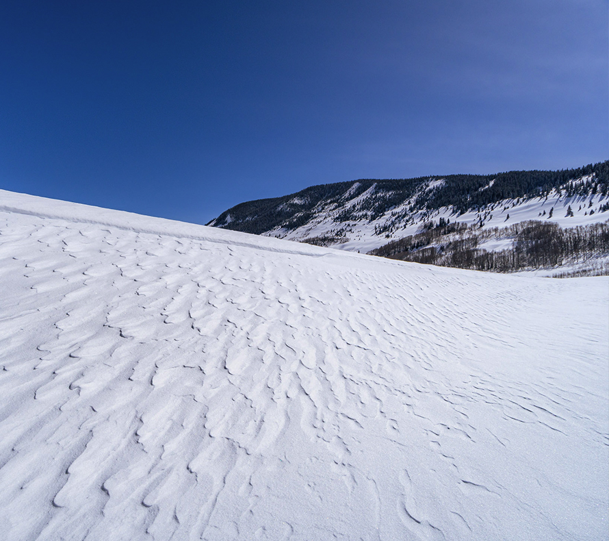 A wind-blown snow drift in the mountains