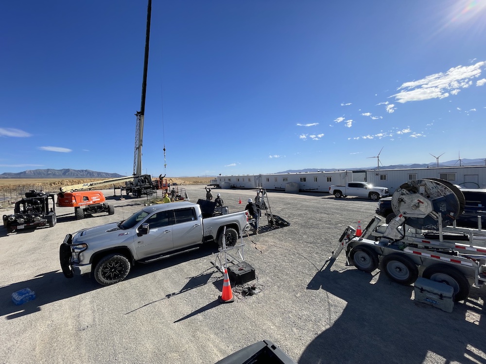 truck surrounded by equipment with big instrument in background
